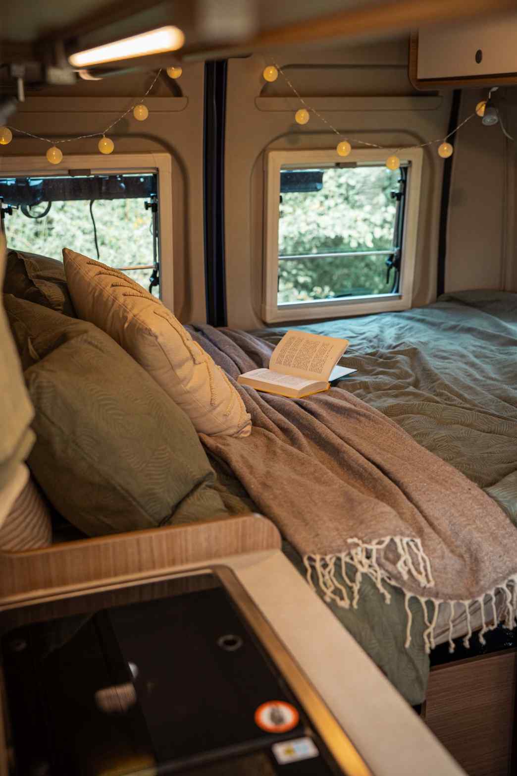 Campervan Carrie - cozy rear bedroom with included linens in the functional 4-sleeper